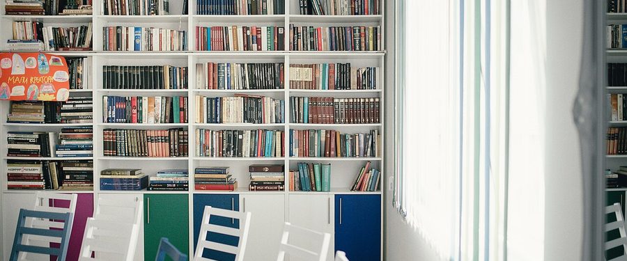 A wall of library bookshelves