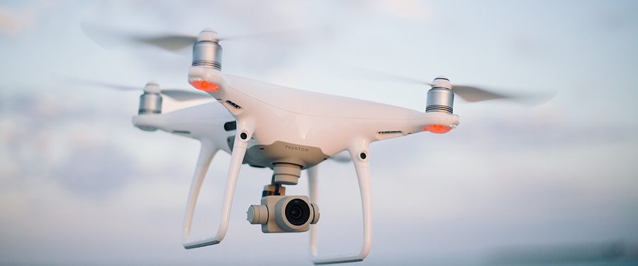 A quadcopter drone in flight against the sky