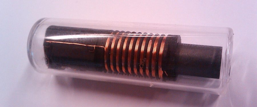 A glass RFID transponder tag with its copper antenna coil